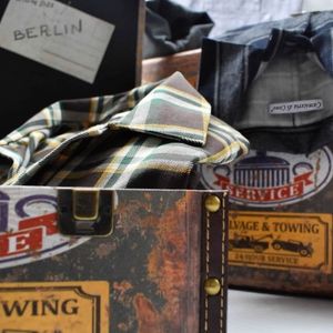 Flannel shirts inside vintage travel trunks