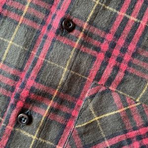 Front detail of red and black checked flannel shirt